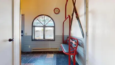 a red chair in a room with a window at Bridges Townhome #5 Condo in Mammoth Lakes