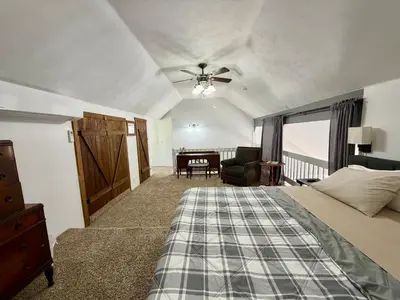 a bedroom with a bed and a chair and a desk at Sierra Mountain Lodge - Vacation Rentals - Yosemite in Ahwahnee