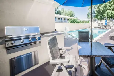 a patio with a grill and a table with chairs at Best Western Bishop Lodge in Bishop