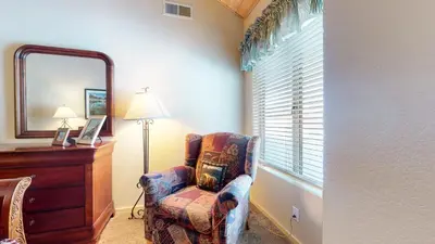 a living room with a chair and a mirror at Snowcreek 622 Condo in Mammoth Lakes
