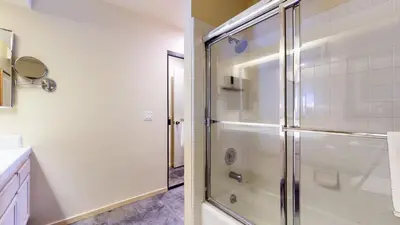 a bathroom with a shower with a glass door at Snowcreek 622 Condo in Mammoth Lakes