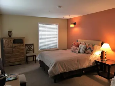 a bedroom with a bed and a window and a dresser at Freeport Wine Country Inn in Freeport