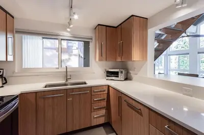 a kitchen with wooden cabinets and a sink and a microwave at Courchevel C # 9 in Mammoth Lakes
