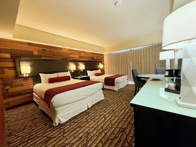 a hotel room with two beds and a desk at Bally's Lake Tahoe Casino Resort in Stateline