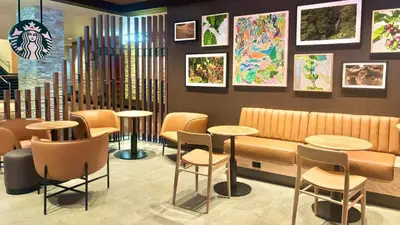 a restaurant with tables and chairs and paintings on the wall at Bally's Lake Tahoe Casino Resort in Stateline