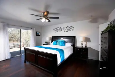 a bedroom with a bed and a ceiling fan at Shady Knoll in Three Rivers