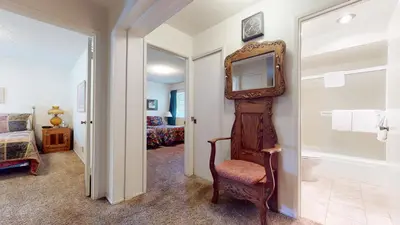 a hallway with a mirror and a chair in a room at Timberline Condominium #44 in Mammoth Lakes