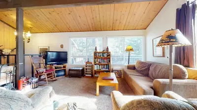 a living room with a couch and a tv at Timberline Condominium #44 in Mammoth Lakes