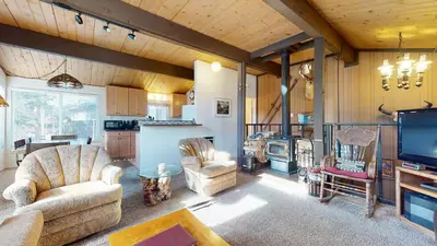 a living room with couches and a tv and a kitchen at Timberline Condominium #44 in Mammoth Lakes