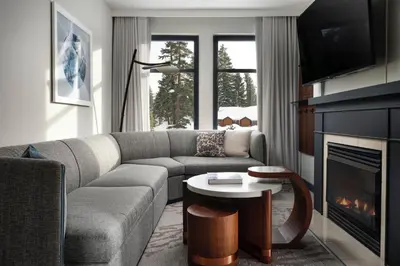 a living room with a couch and a fireplace at The Westin Monache Resort, Mammoth in Mammoth Lakes