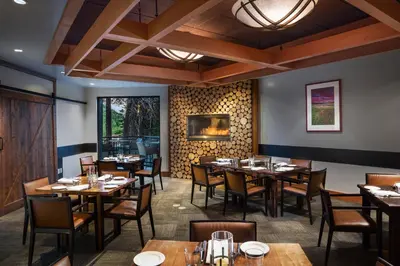 a dining room with wooden tables and chairs at The Westin Monache Resort, Mammoth in Mammoth Lakes