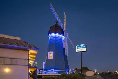 a tall blue building with a sign in front of it at Howard Johnson by Wyndham Modesto Ceres in Ceres