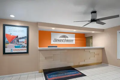 a hotel lobby with a sign on the wall at Howard Johnson by Wyndham Modesto Ceres in Ceres