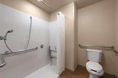 a bathroom with a toilet and a shower at Howard Johnson by Wyndham Modesto Ceres in Ceres