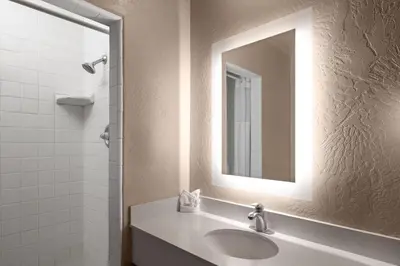 a bathroom with a sink and a mirror at Howard Johnson by Wyndham Modesto Ceres in Ceres
