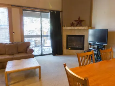 a living room with a couch a table and a television at 3130 Aspen Grove in Truckee
