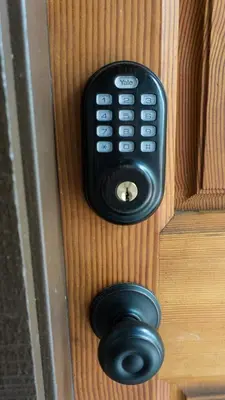 a black remote control on a wooden door at 4081 Ski Trails in Truckee