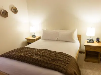 a bedroom with a bed with two nightstands and two lamps at 4081 Ski Trails in Truckee