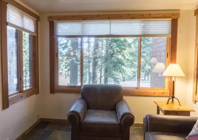 a living room with a chair and a large window at 4025 Ski Trails in Truckee