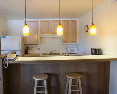 a kitchen with two bar stools and three lights at 4025 Ski Trails in Truckee
