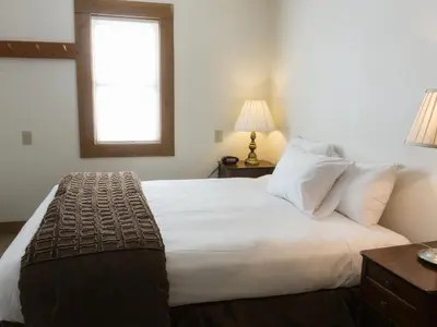 a bedroom with a large white bed with a window at 3132 Aspen Grove in Truckee