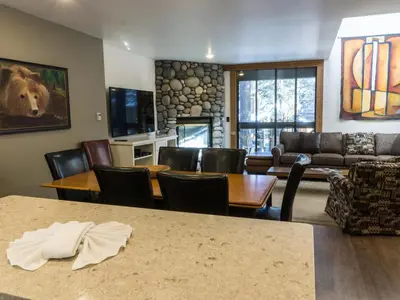 a living room with a couch and a table and chairs at 3132 Aspen Grove in Truckee