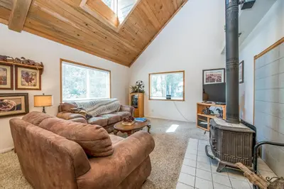 a living room with two couches and a fireplace at Sparrow Cove in Shaver Lake