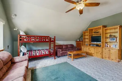 a living room with a red bunk bed and a couch at The Rockin' Buffalo in Shaver Lake