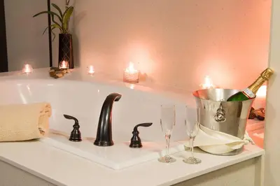 a bath tub with a sink with wine glasses on it at Jackson Rancheria Casino Resort in Jackson