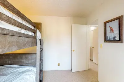 a bedroom with a bunk bed and an open door at Sierra Sky in Tahoe City