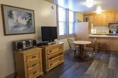 a living room with a table and a kitchen at 3159 Aspen Grove in Truckee