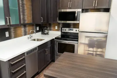 a kitchen with wooden cabinets and stainless steel appliances at Residence Inn by Marriott Reno Sparks in Sparks