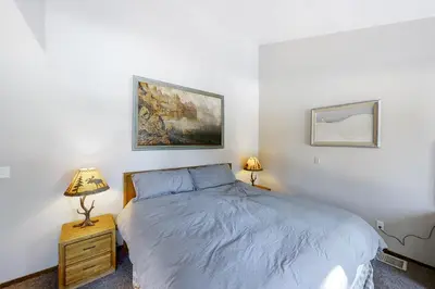 a bedroom with a bed and two lamps on a night stand at Eagles Nest Condo #88 in Lakeshore