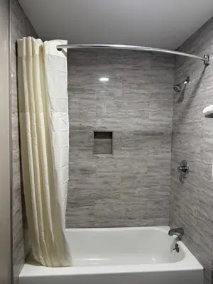 a bathroom with a bath tub with a shower curtain at Tahoe Sands Inn in South Lake Tahoe