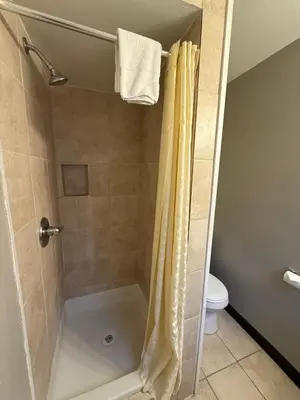 a shower with a shower curtain in a bathroom at Tahoe Sands Inn in South Lake Tahoe