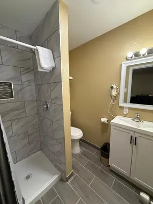 a bathroom with a shower and a toilet and a sink at Tahoe Sands Inn in South Lake Tahoe