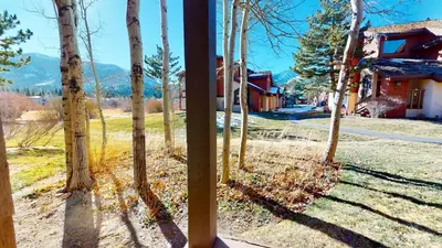 a view of a yard with trees and a house at Snowcreek Iii #415 Condo in Mammoth Lakes