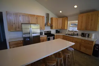 a kitchen with wooden cabinets and a stainless steel refrigerator at Mountain Place in Groveland