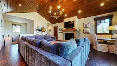a living room with a large couch and a fireplace at Gray Stone Condo #2110 in Mammoth Lakes