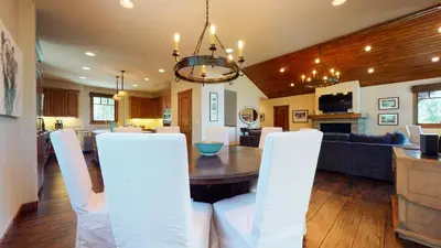 a dining room and living room with a table and chairs at Gray Stone Condo #2110 in Mammoth Lakes