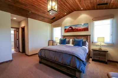 a bedroom with a large bed with blue pillows at Gray Stone Condo #2110 in Mammoth Lakes