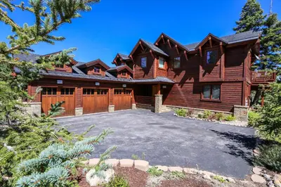 a log home with a driveway in front of it at Gray Stone Condo #2110 in Mammoth Lakes