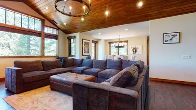 a living room with a large couch and a table at Gray Stone Condo #2110 in Mammoth Lakes