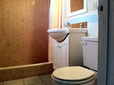 a bathroom with a toilet and a sink at Village Inn in Tulare