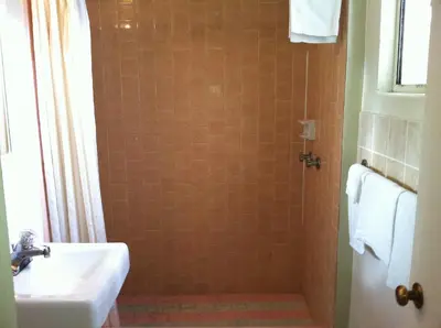 a bathroom with a sink and a shower at Village Inn in Tulare