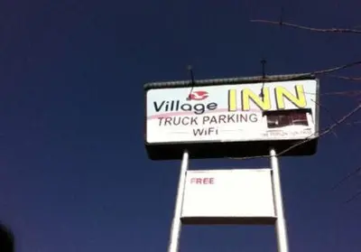 a sign for the village inn truck parking at Village Inn in Tulare