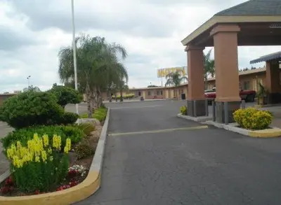 an empty street in front of a gas station at Village Inn in Tulare