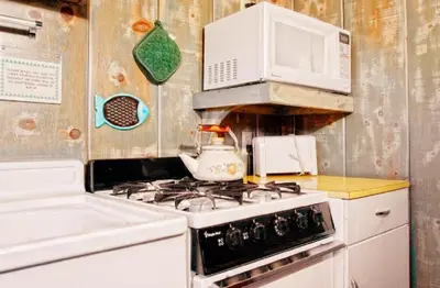 a kitchen with a stove and a microwave at June Lake Motel in June Lake