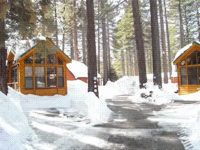 a cabin in the woods covered in snow at Cedar Pines Resort in South Lake Tahoe