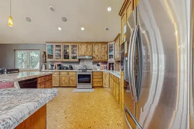 a large kitchen with wooden cabinets and a refrigerator at Elegant Pine in South Lake Tahoe